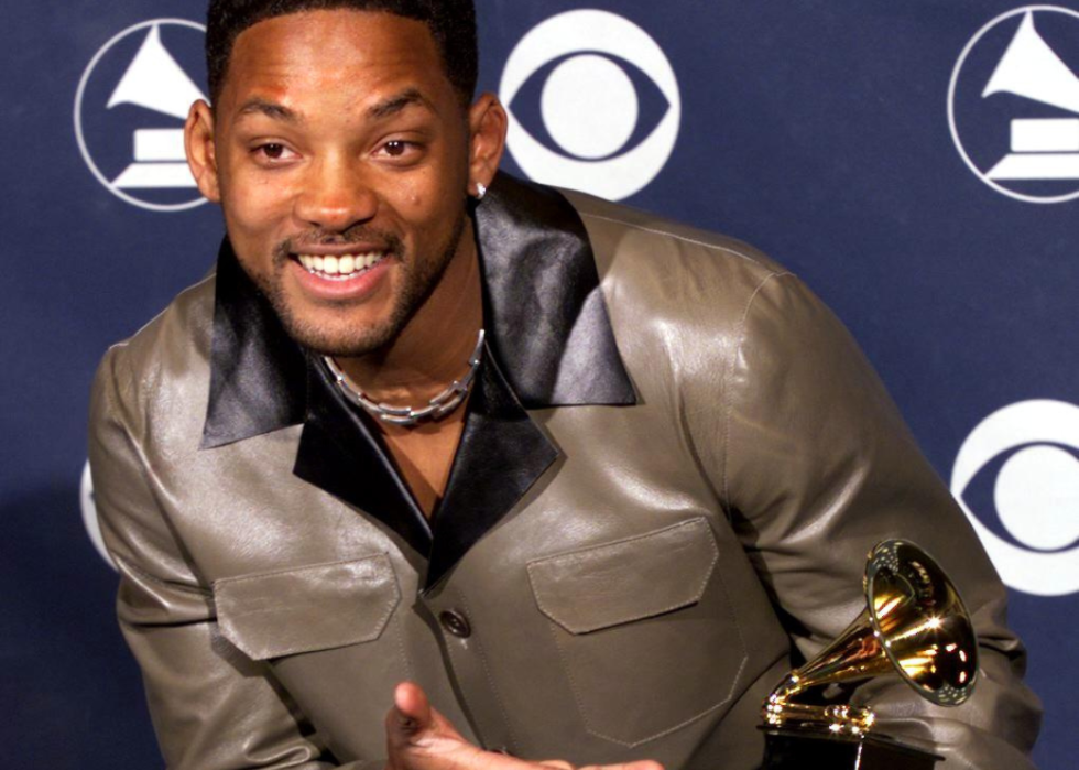 Will Smith posing with a Grammy Award.