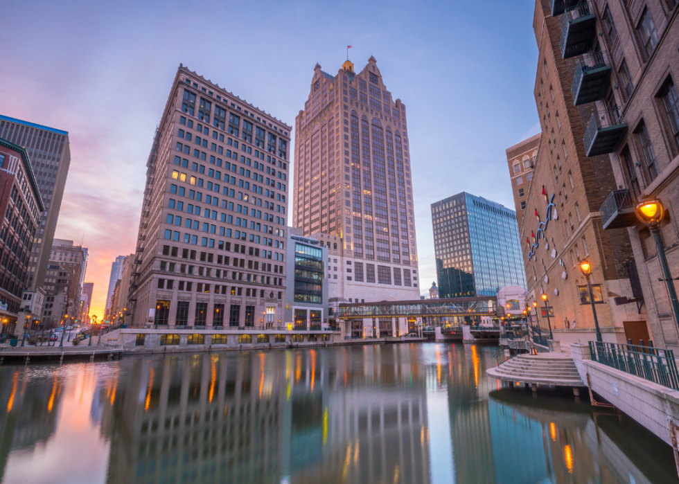 Tall buildings along the river in a city downtown.