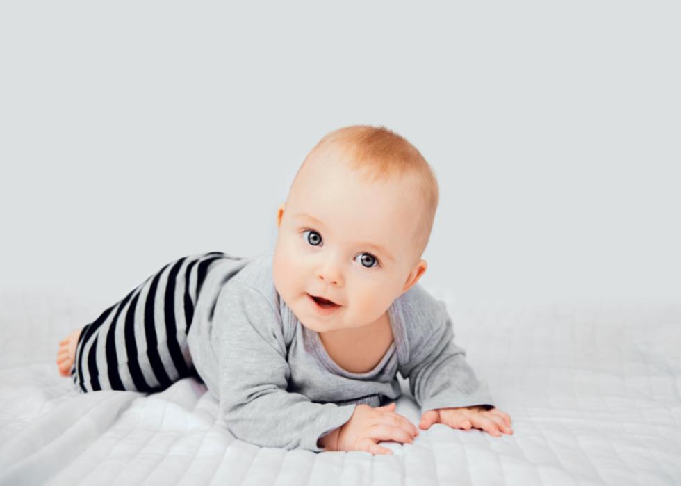 Baby on a white soft blanket. 