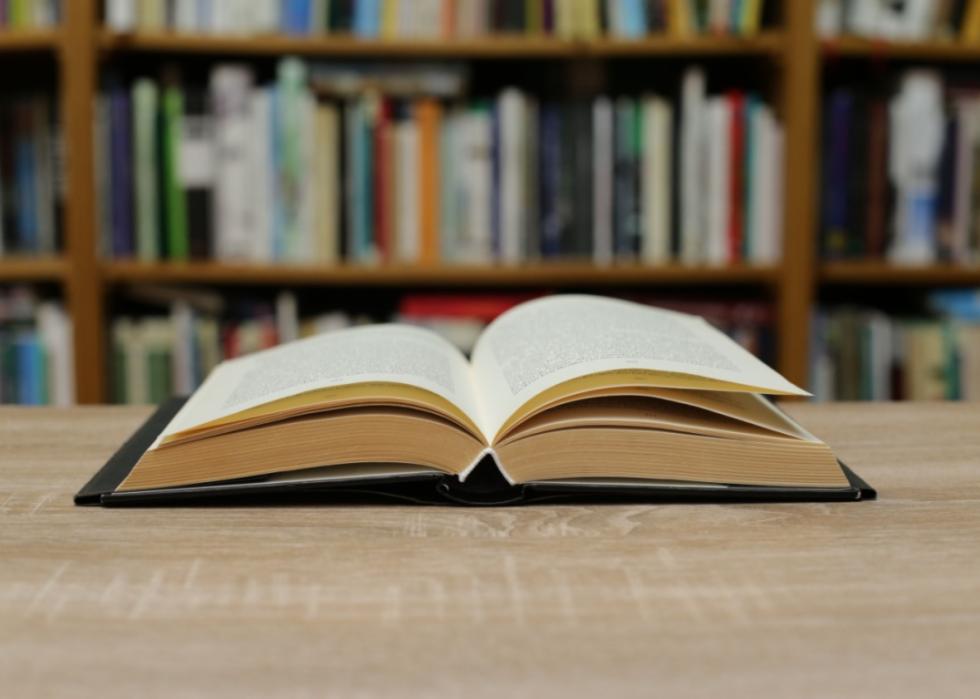 A book open on a library table.