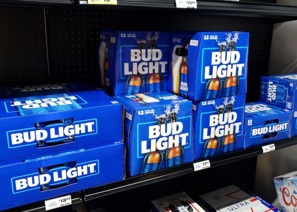 Bud Light cases on a shelf in a convenient store.