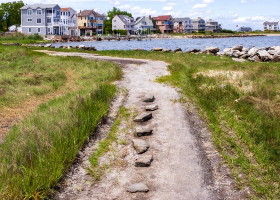 A small path and homes on the water.