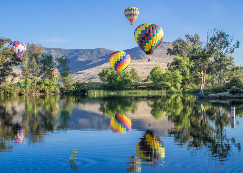 Hot air balloons over water.