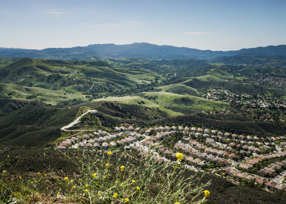 An aerial view of homes in sprawling green hills.