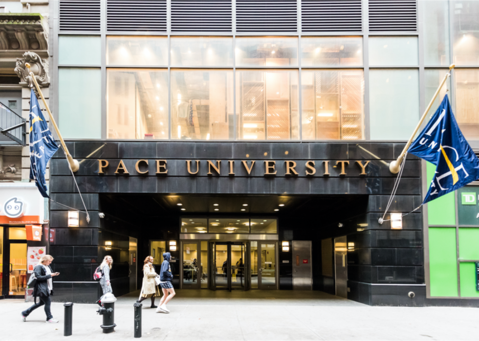 People walking by the entrance to Pace University.