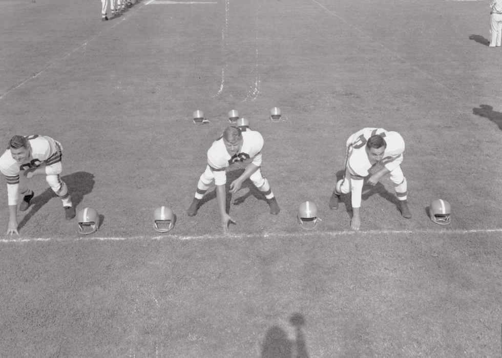 At their positions in training camp, O. Dante Lavelli, right end; Frank Gatski, center; and Lou Groza, left tackle, 1946.