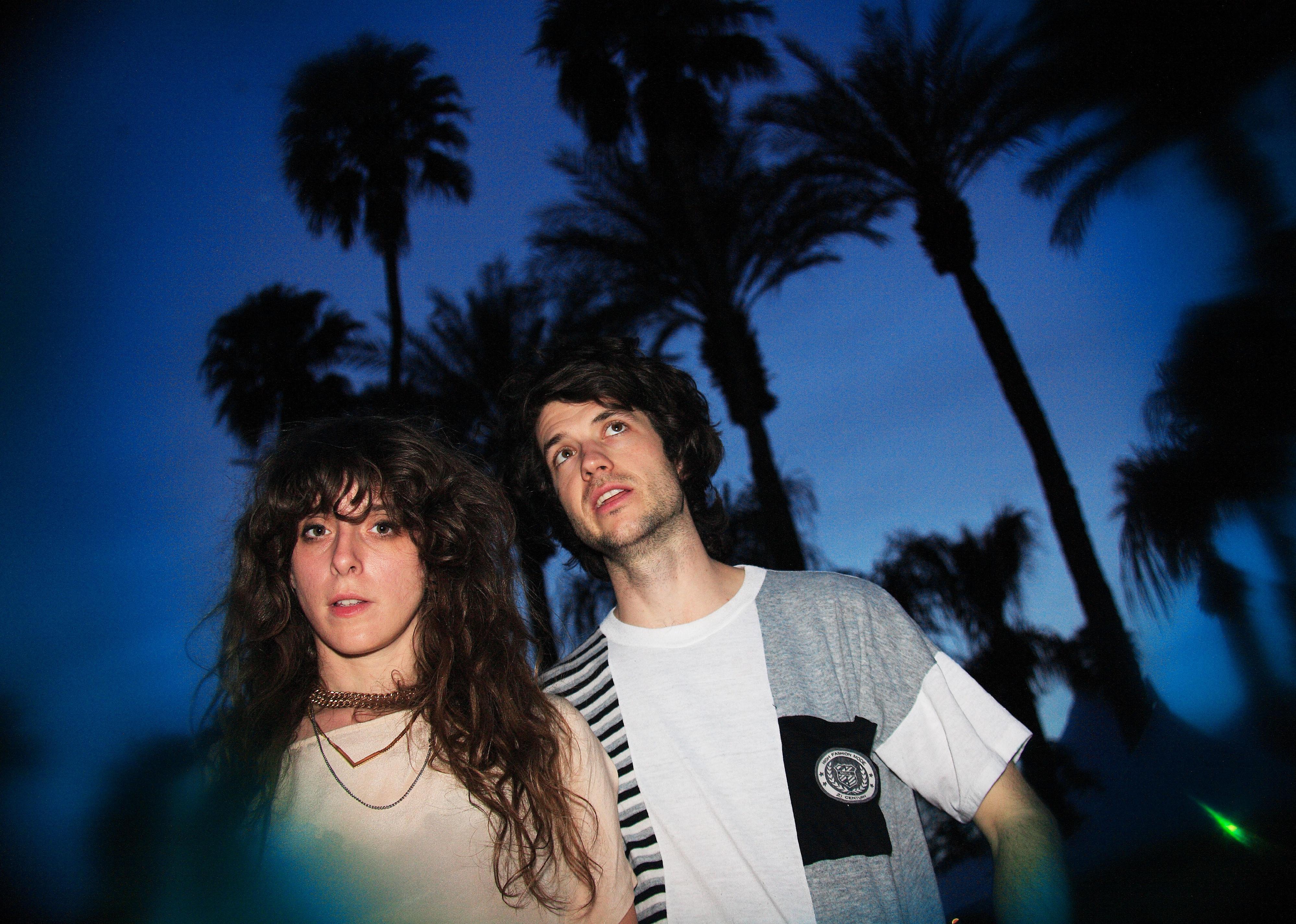 Beach House pose in front of palm trees