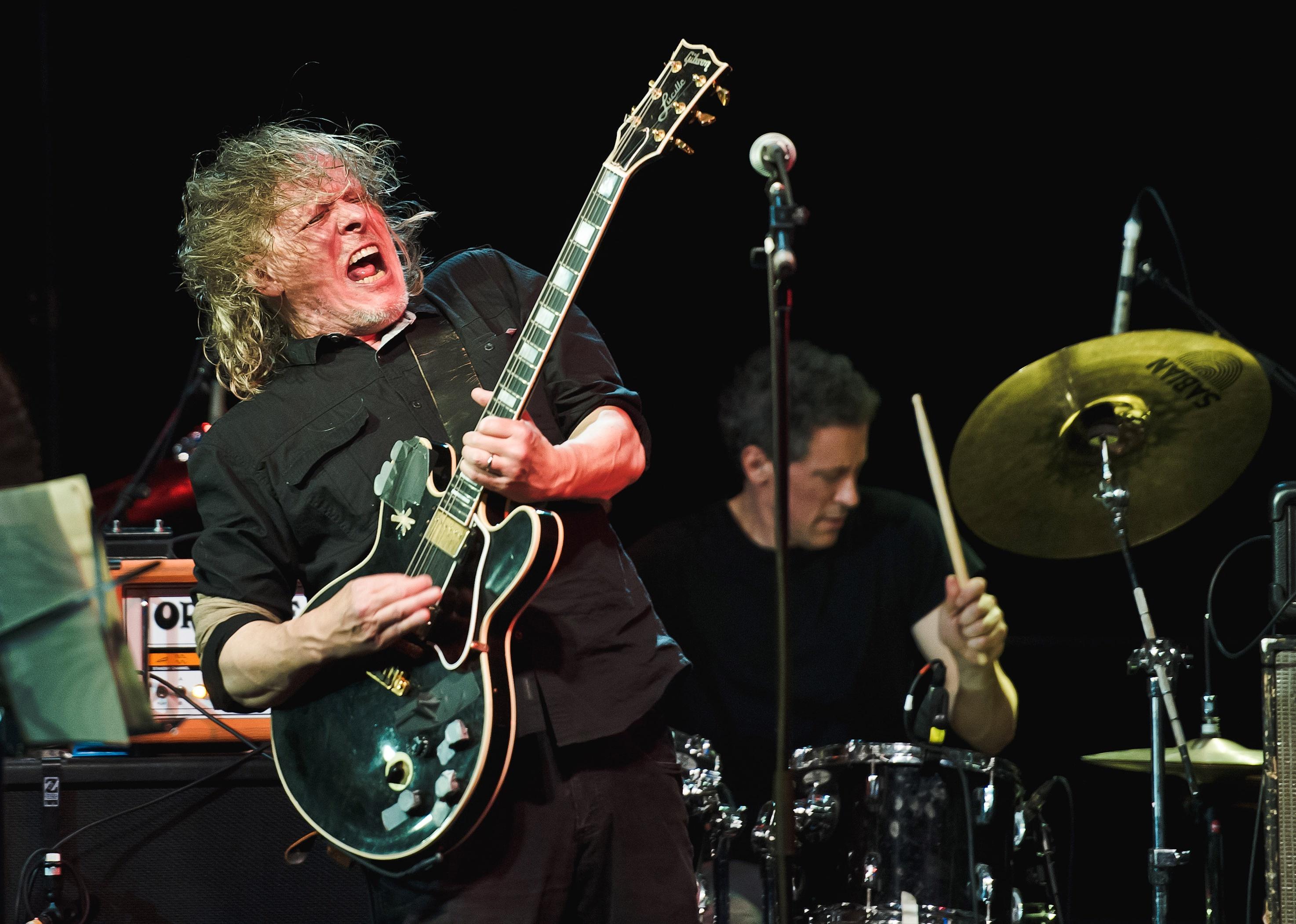 Michael Gira of Swans plays a guitar