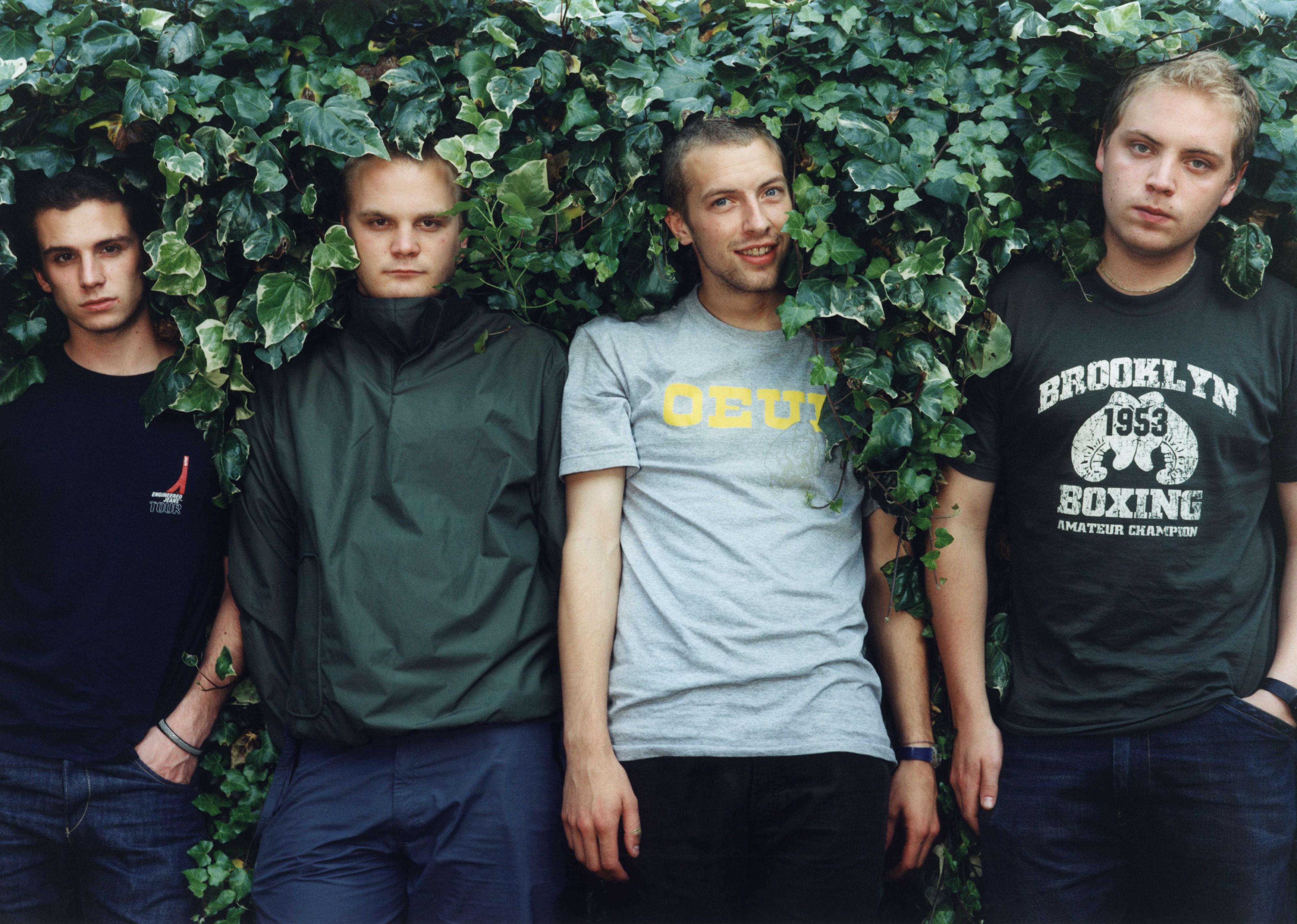 Coldplay band members pose for a photo