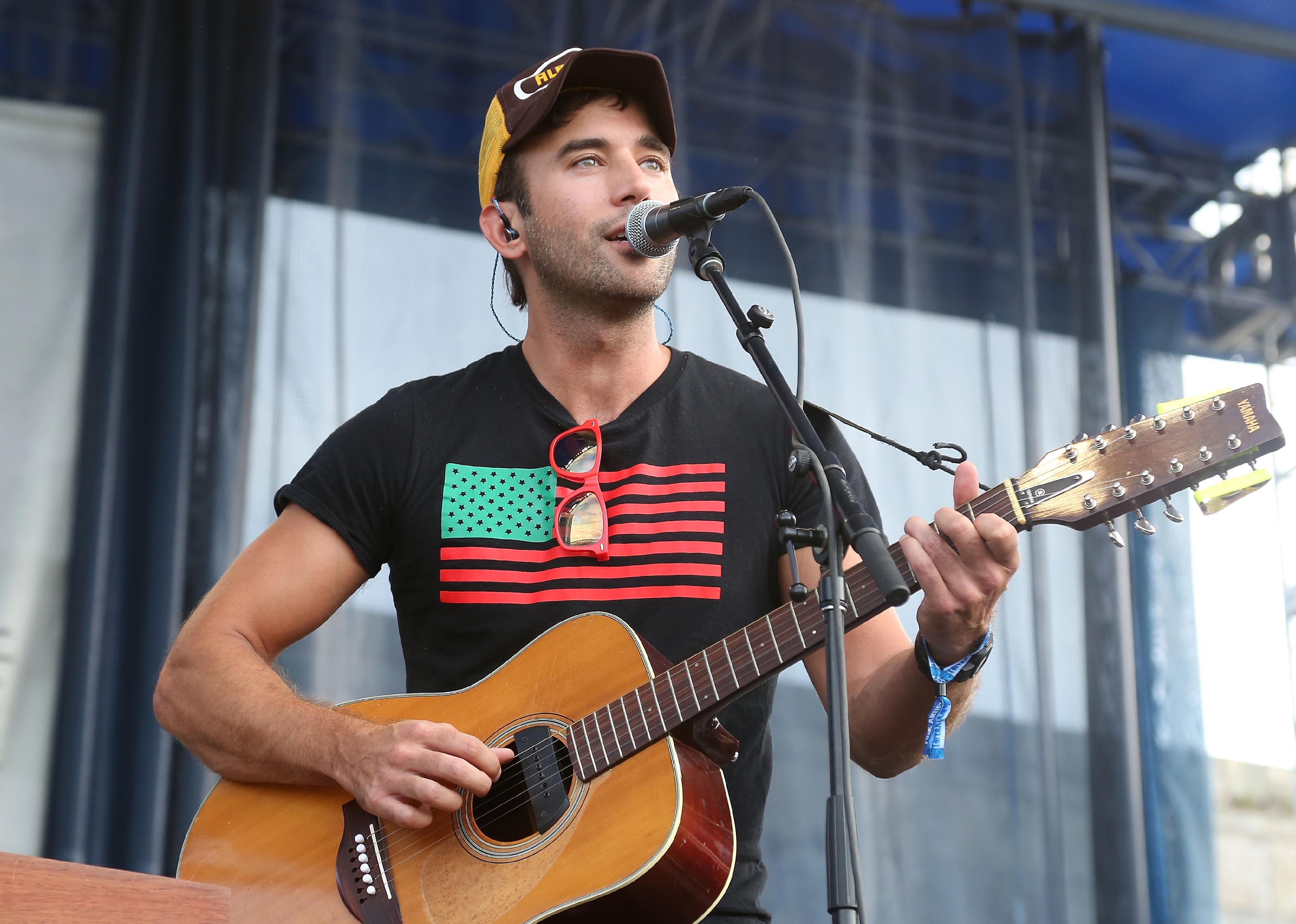 Sufjan Stevens plays a guitar
