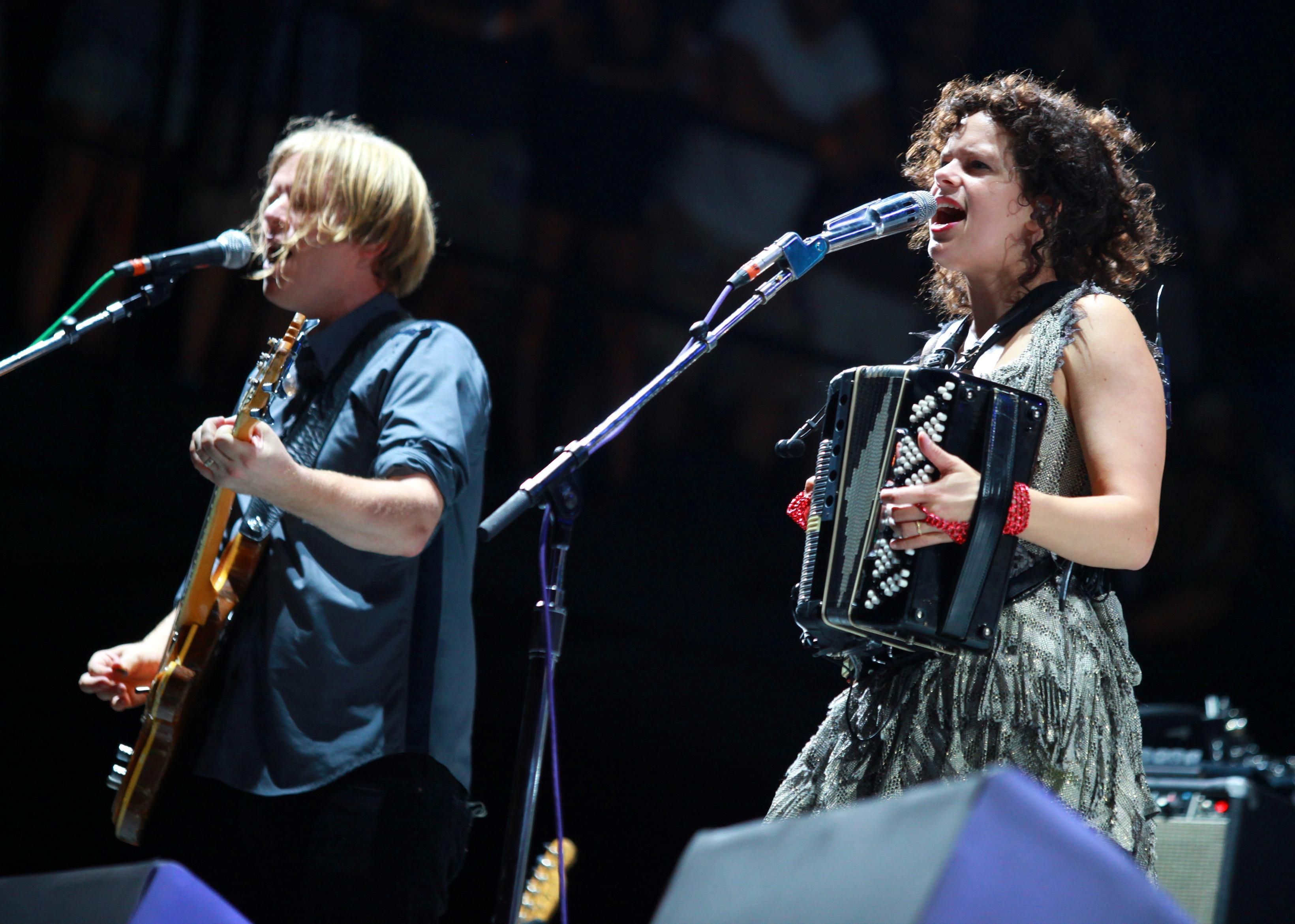 Arcade Fire perform at a concert