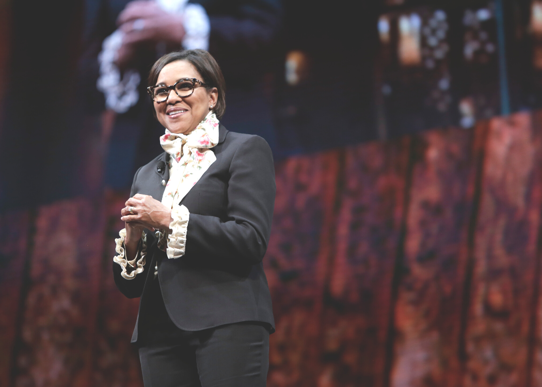 Roz Brewer, in a black suit with a floral top, speaks onstage.