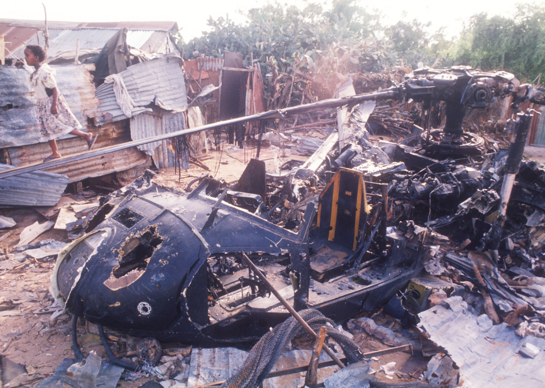 A child walking along the rotor of a wrecked American helicopter in Mogadishu, Somalia.
