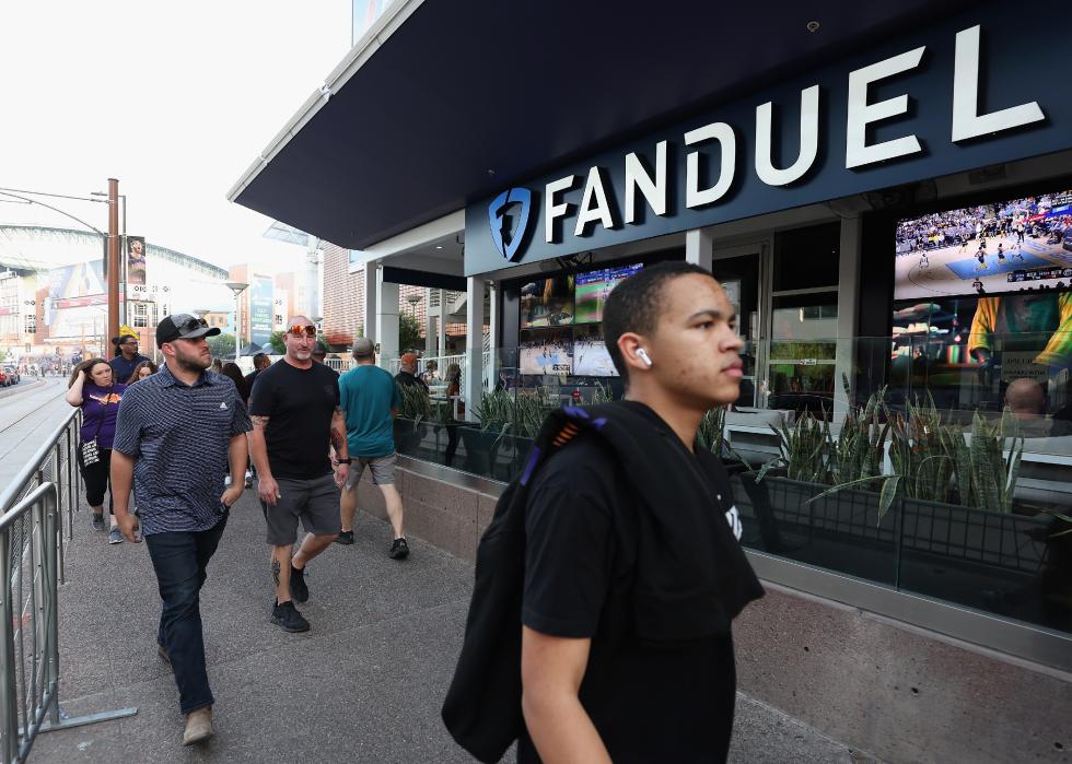 Fans walk past a Fanduel sports betting location at Footprint Center in Phoenix, Arizona. 