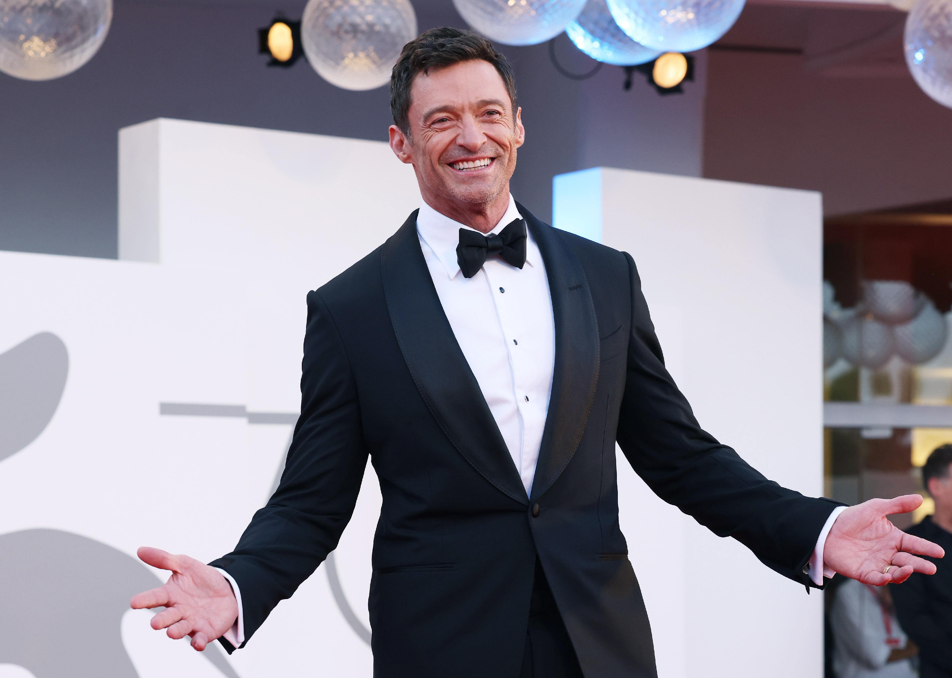 Hugh Jackman in a black suit and bowtie.