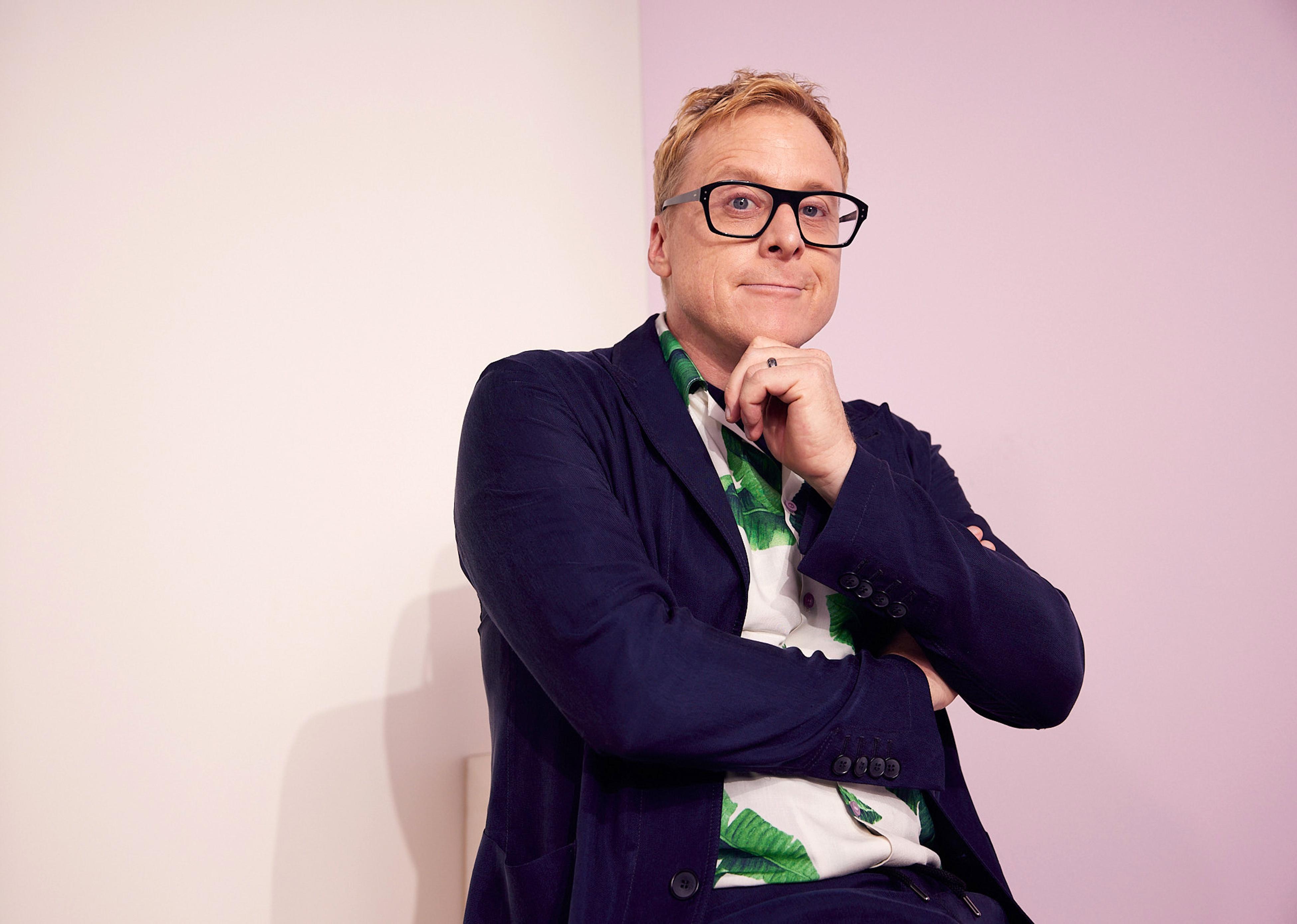 Alan Tudyk in a navy blazer and palm tree shirt.
