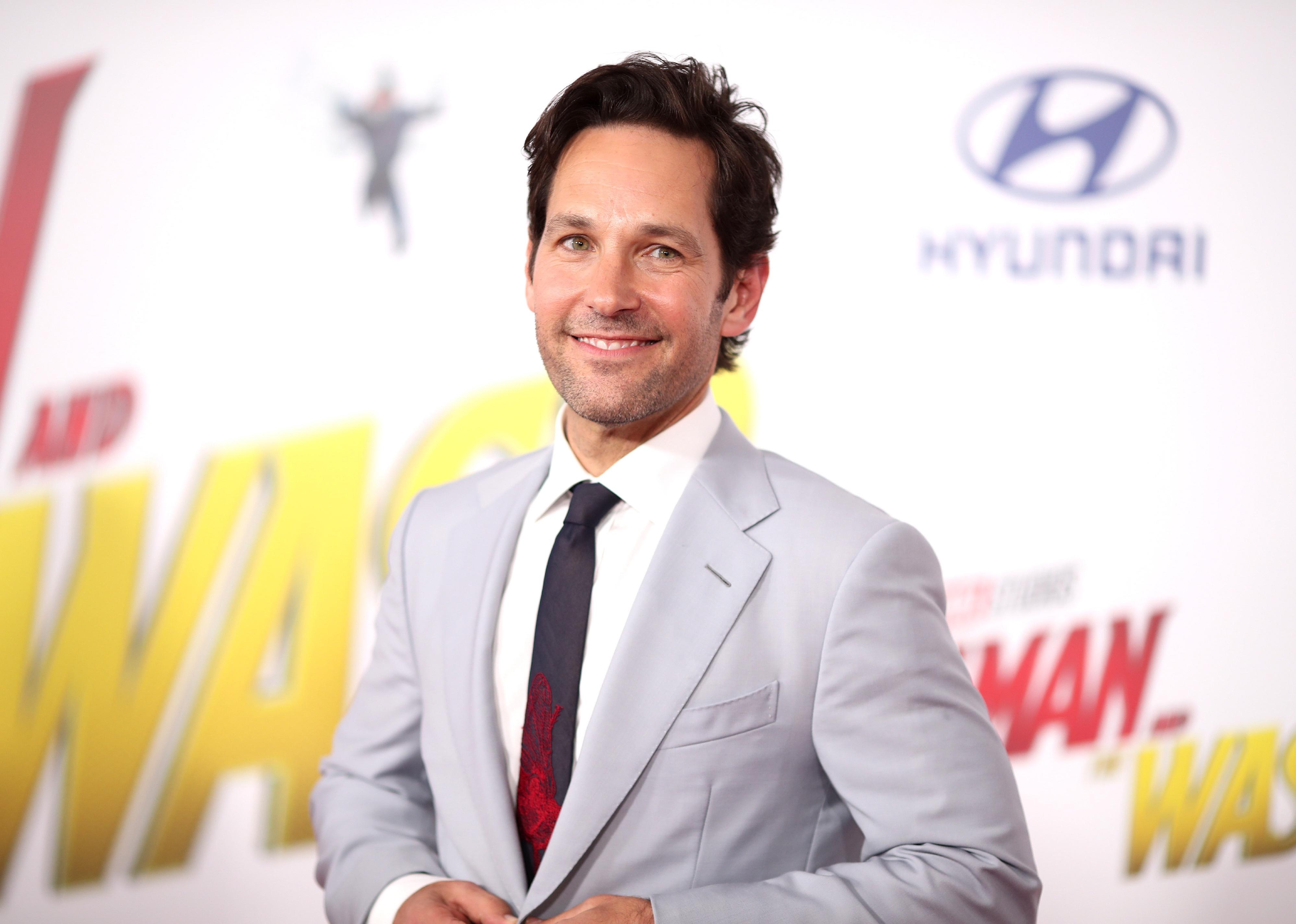 Paul Rudd in a grey suit.