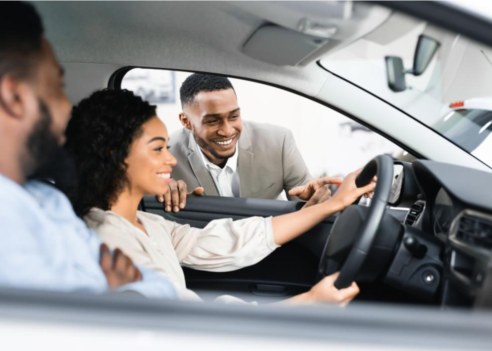 Man and woman getting ready to test drive a car.