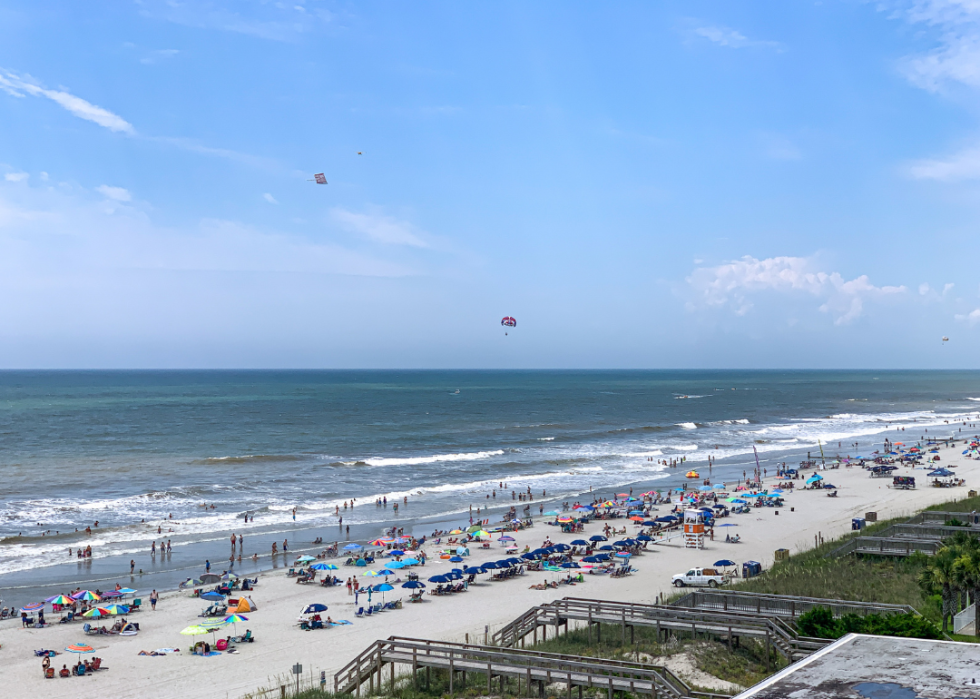 Beach busy with people having fun.