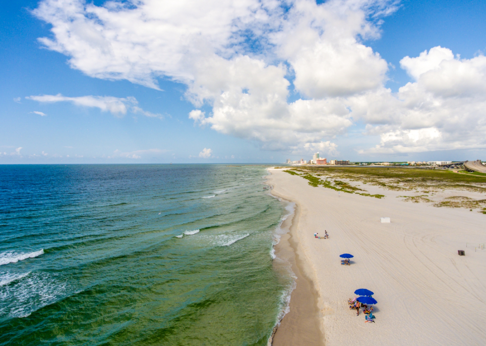 Aerial view of coastlines and umbrella beach setups.