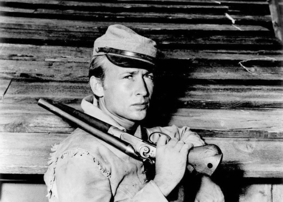 A man and a woman standing on a parked airplane.