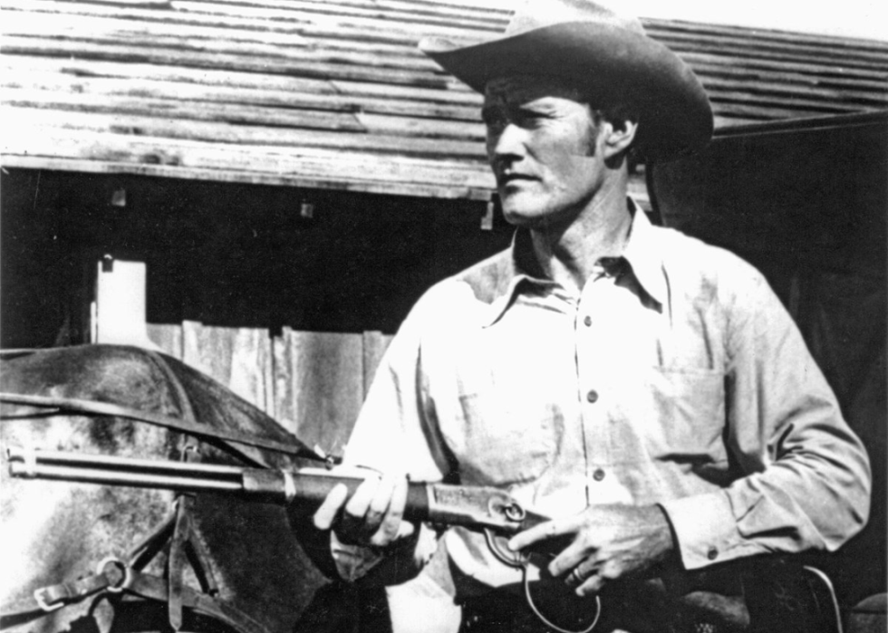Chuck Connors holding a rifle.