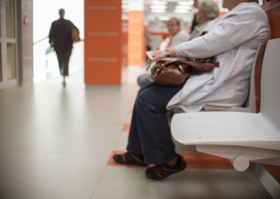 Patients sitting in the waiting room in a doctors' office.