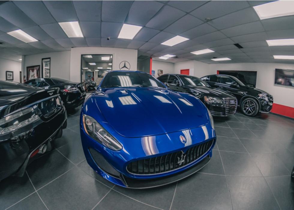 Luxury used cars inside dealership in Plano, Texas.