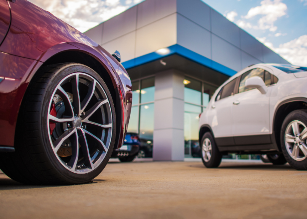 Close-up of wheels at used car dealership.