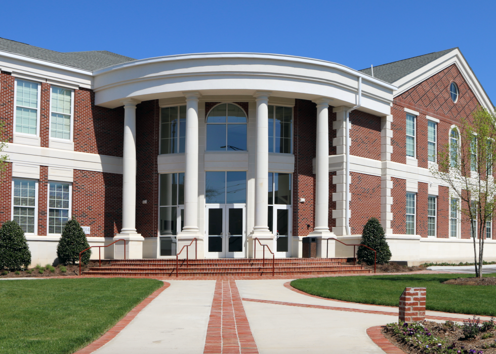 A red brick building with a round front and white columns.