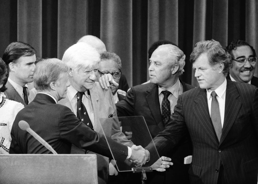 President Carter and Sen. Edward Kennedy finally shake hands as Democratic Convention chairman Thomas "Tip" O'Neill and Carter campaign manager Robert Strauss bring them together on the podium at the conclusion of the Democratic Convention in New York.