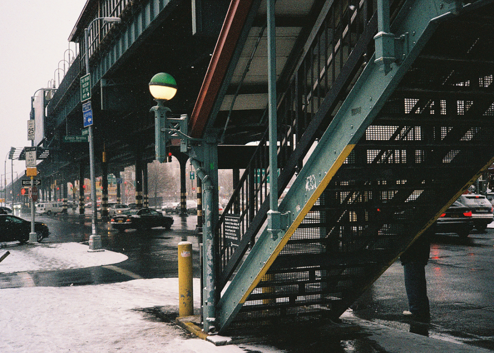 Cars in the snow near the subway.