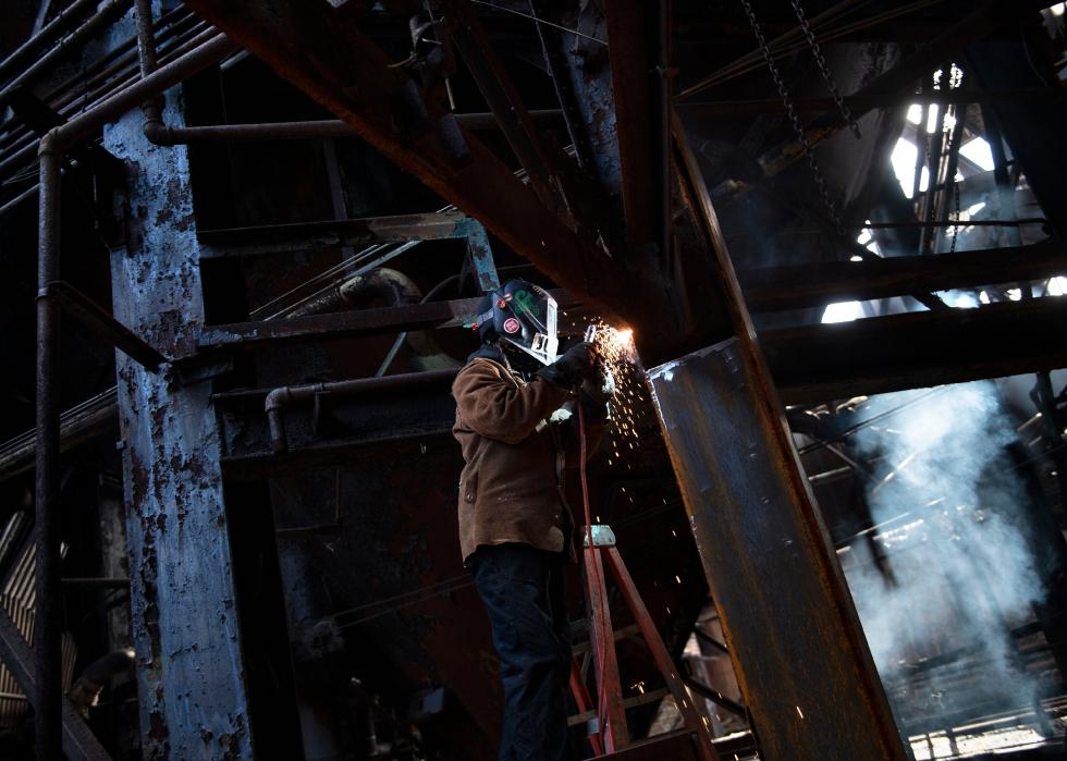A steel worker performs maintenance at the Carrie Furnace.