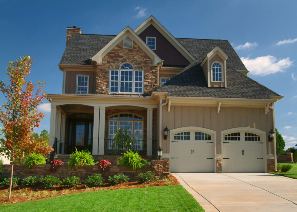 A stone home with two-car garage.