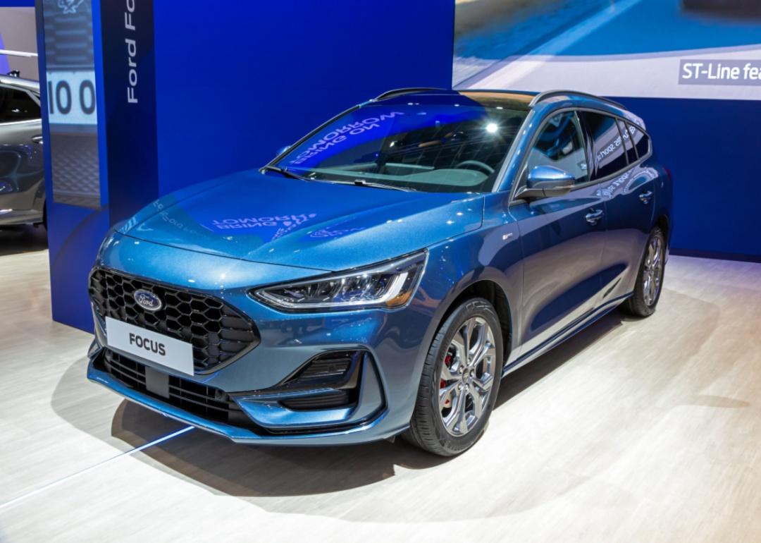 A blue Ford Focus in a showroom.