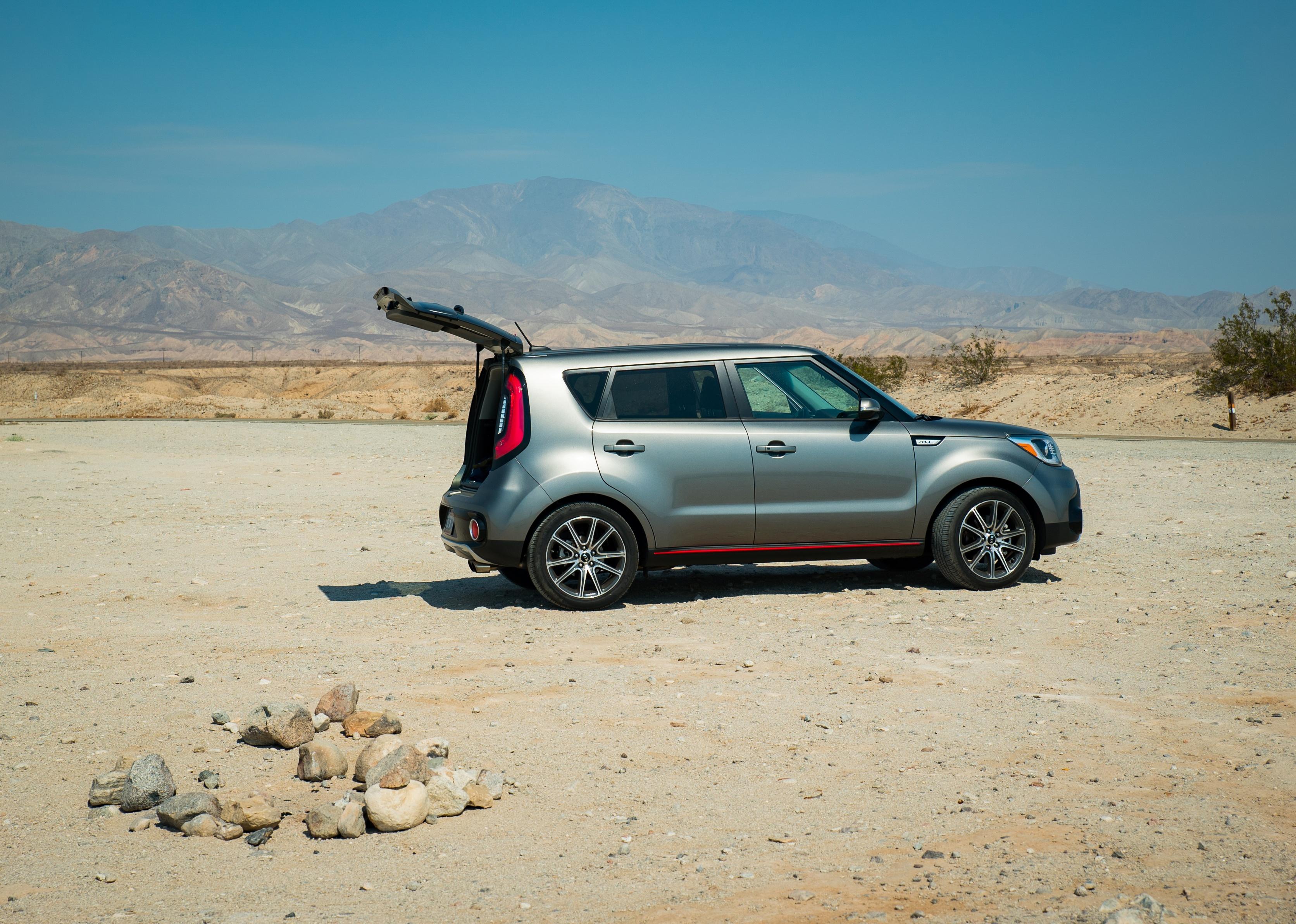 A gray Kia Soul in the desert.