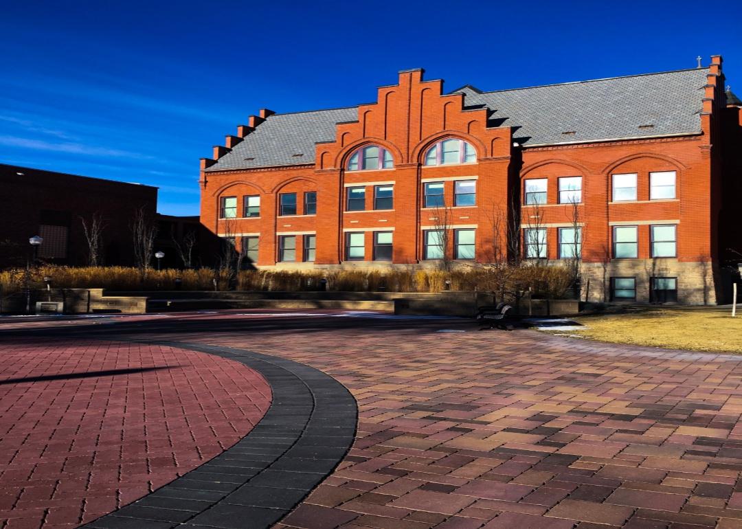 A red brick building with a circular brick driveway