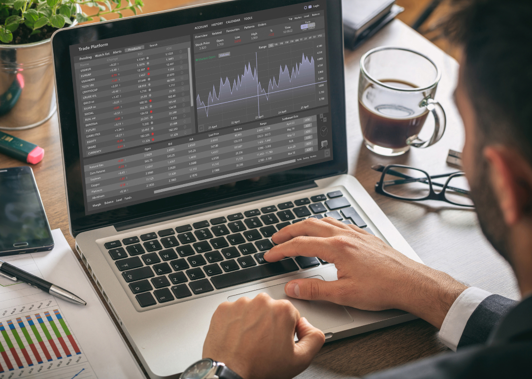 Man looking at stock market data on computer.