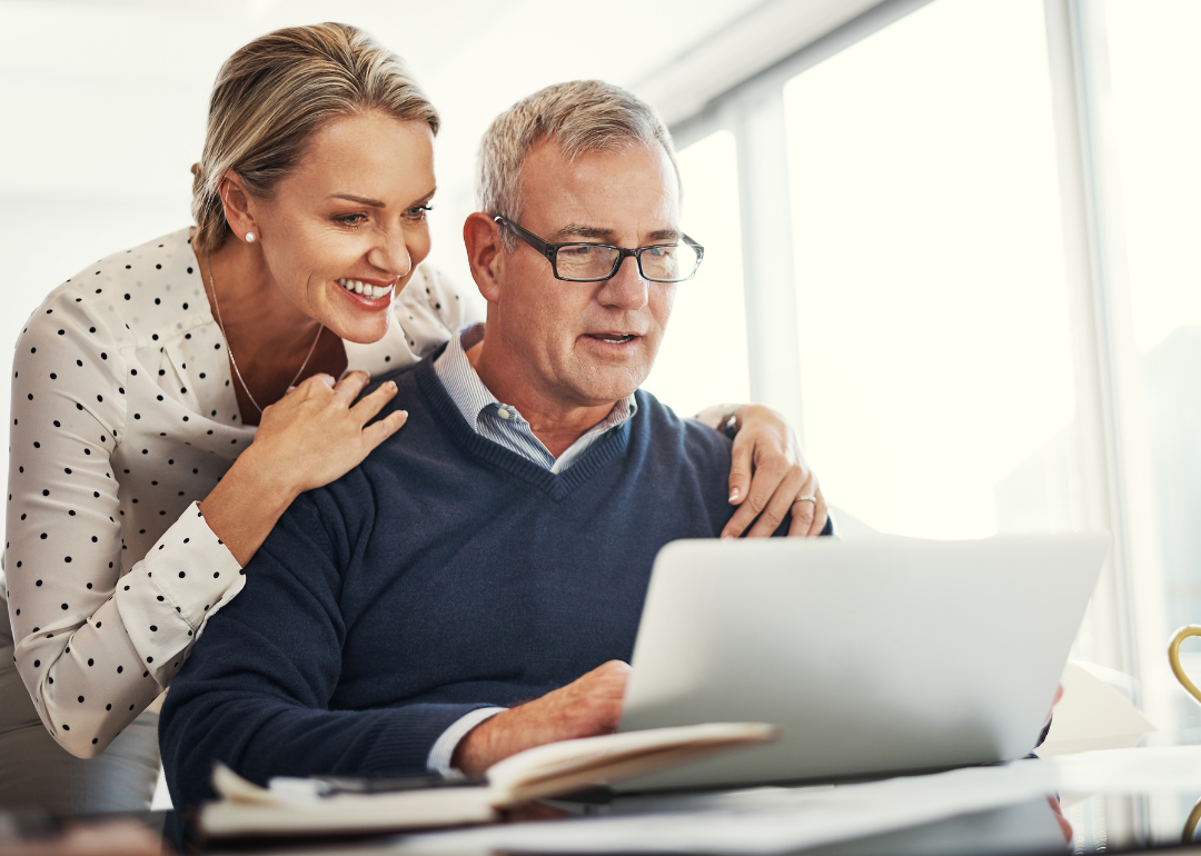 Couple looking at computer at home.