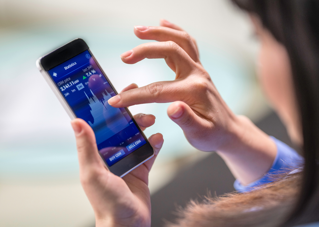 Woman tracking financial investments on app.