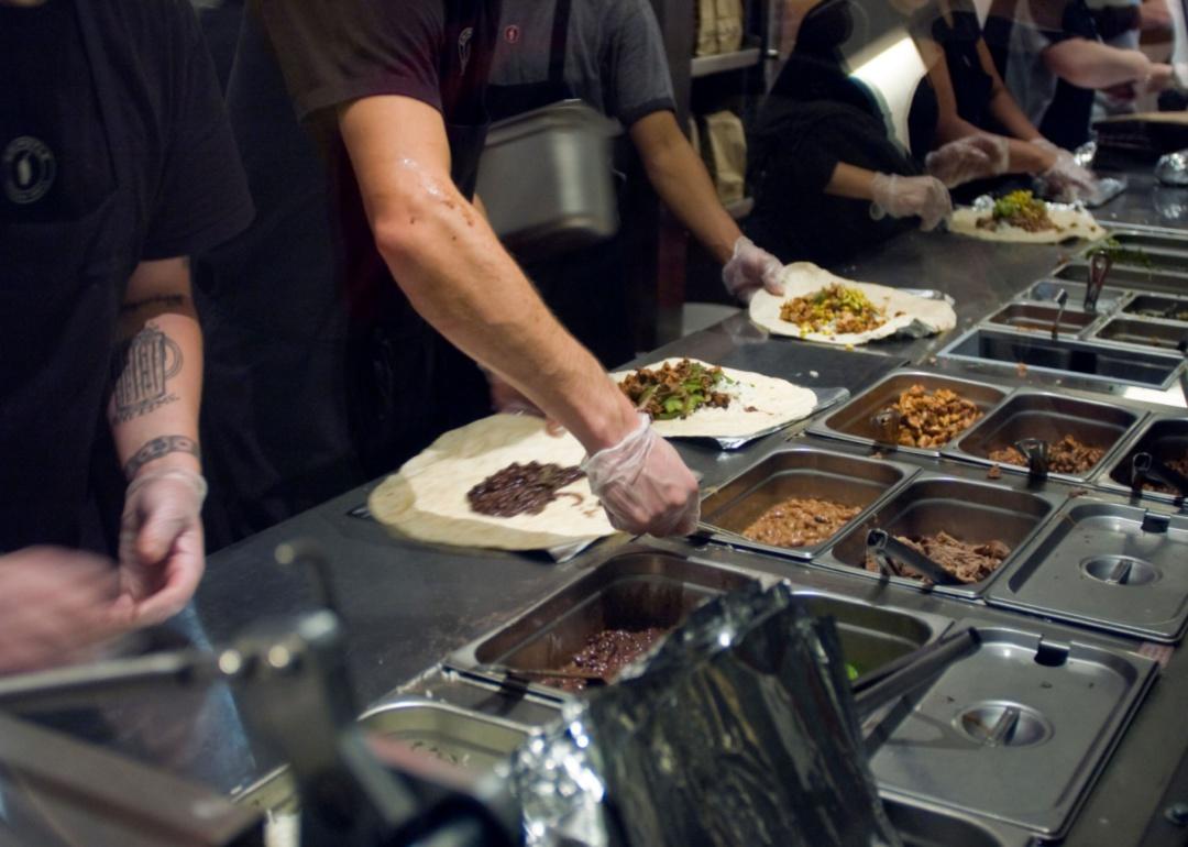 Chipotle employees making burritos.