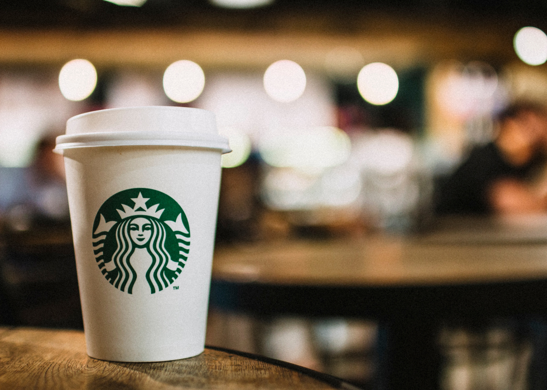 A Starbucks coffee cup on a table.