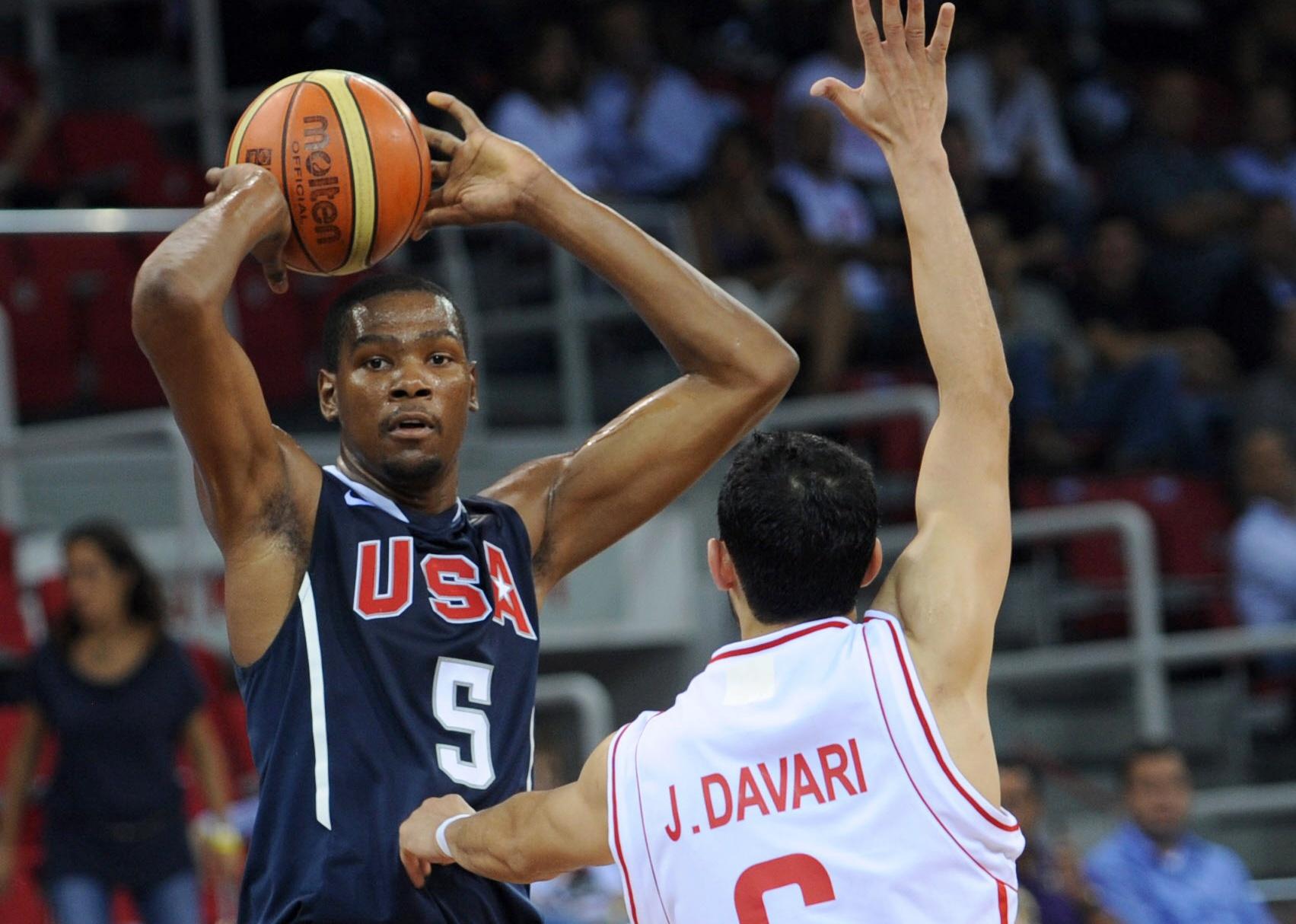 Javad Davari of Iran vies with Kevin Durant during a preliminary match between Iran and USA.