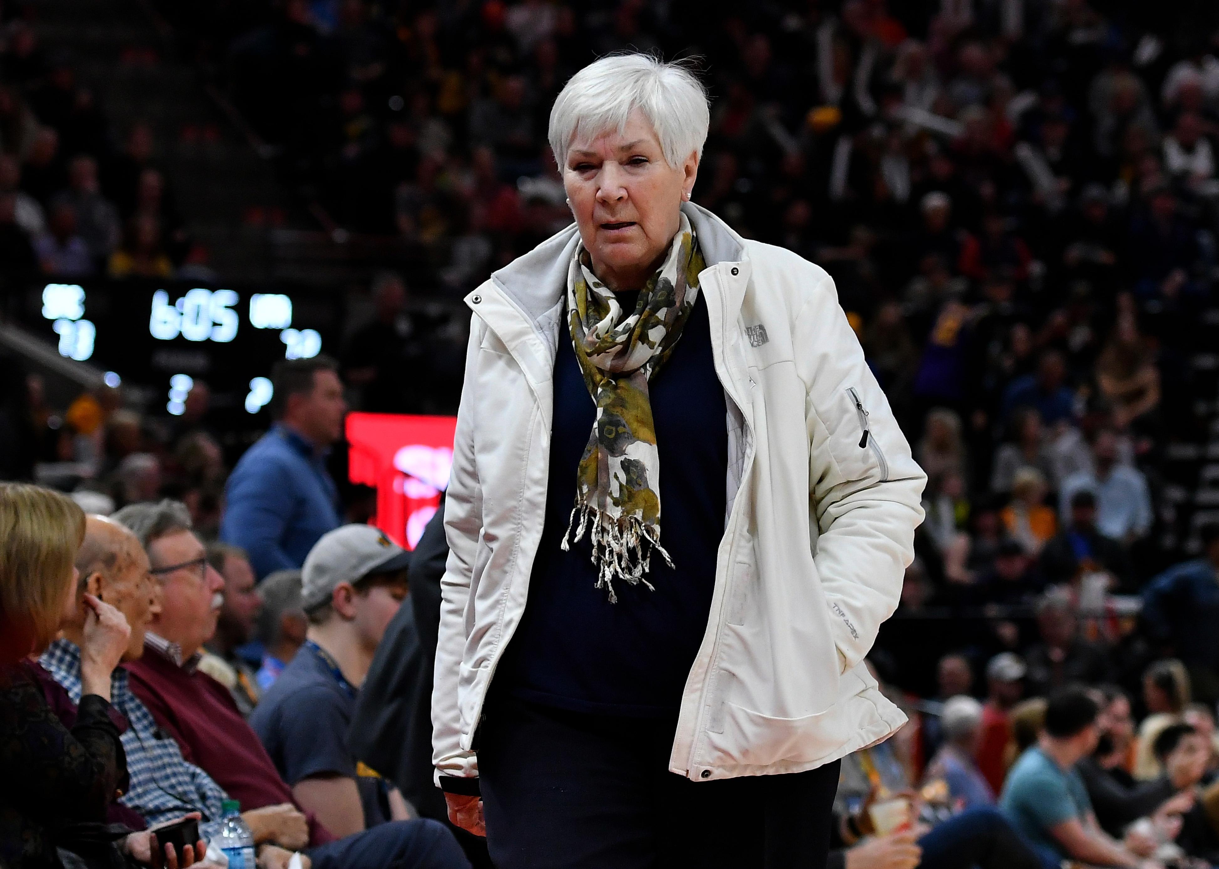 Gail Miller walks off court during an NBA game