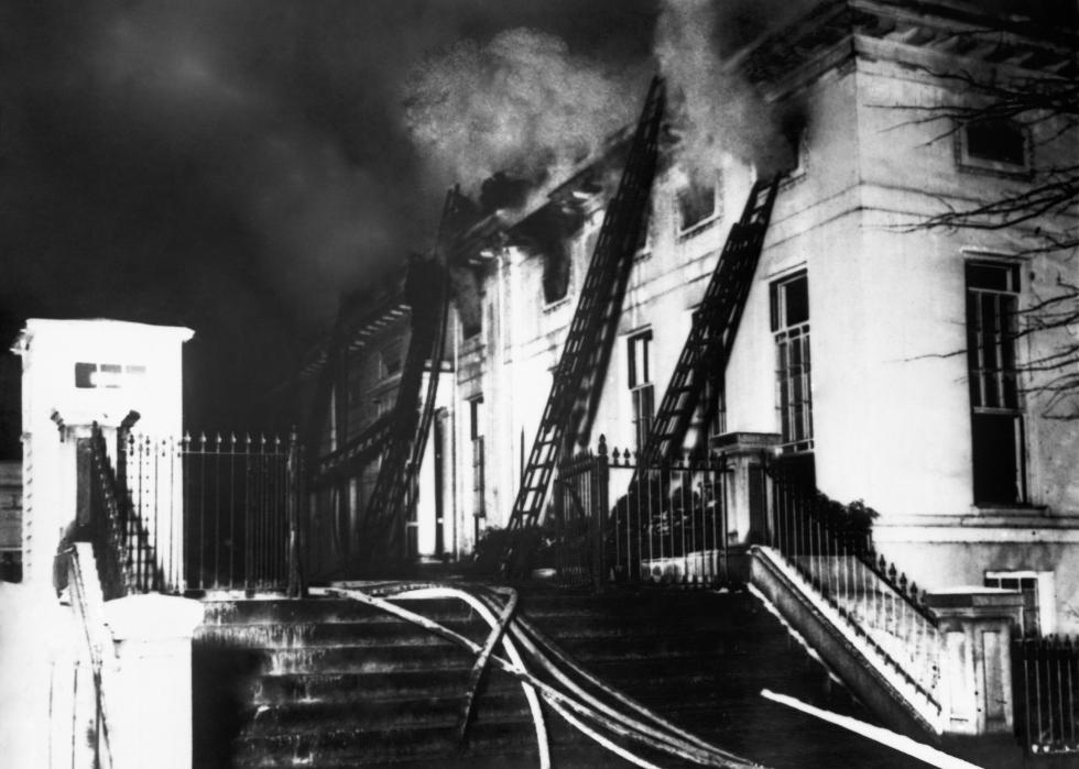 The White House fire underway with fire hoses and ladders.