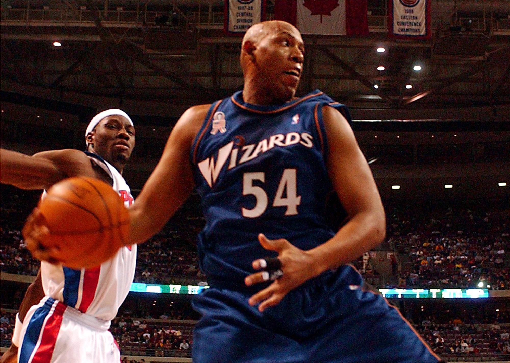 Popeye Jones pulls down a rebound in front of Detroit Pistons Ben Wallace.