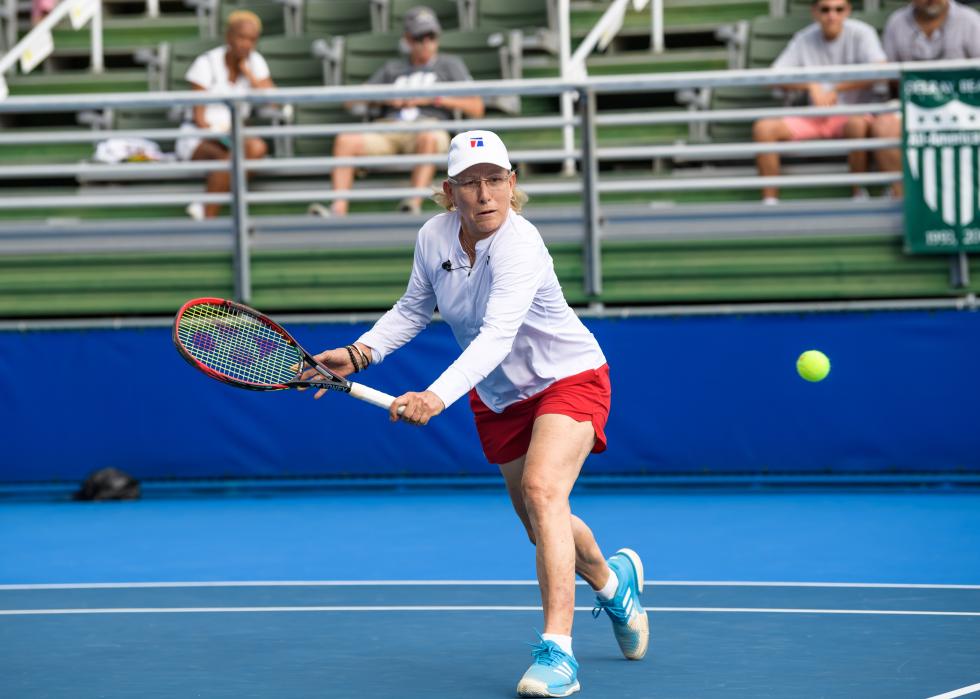 Martina Navratilova backhands a ball