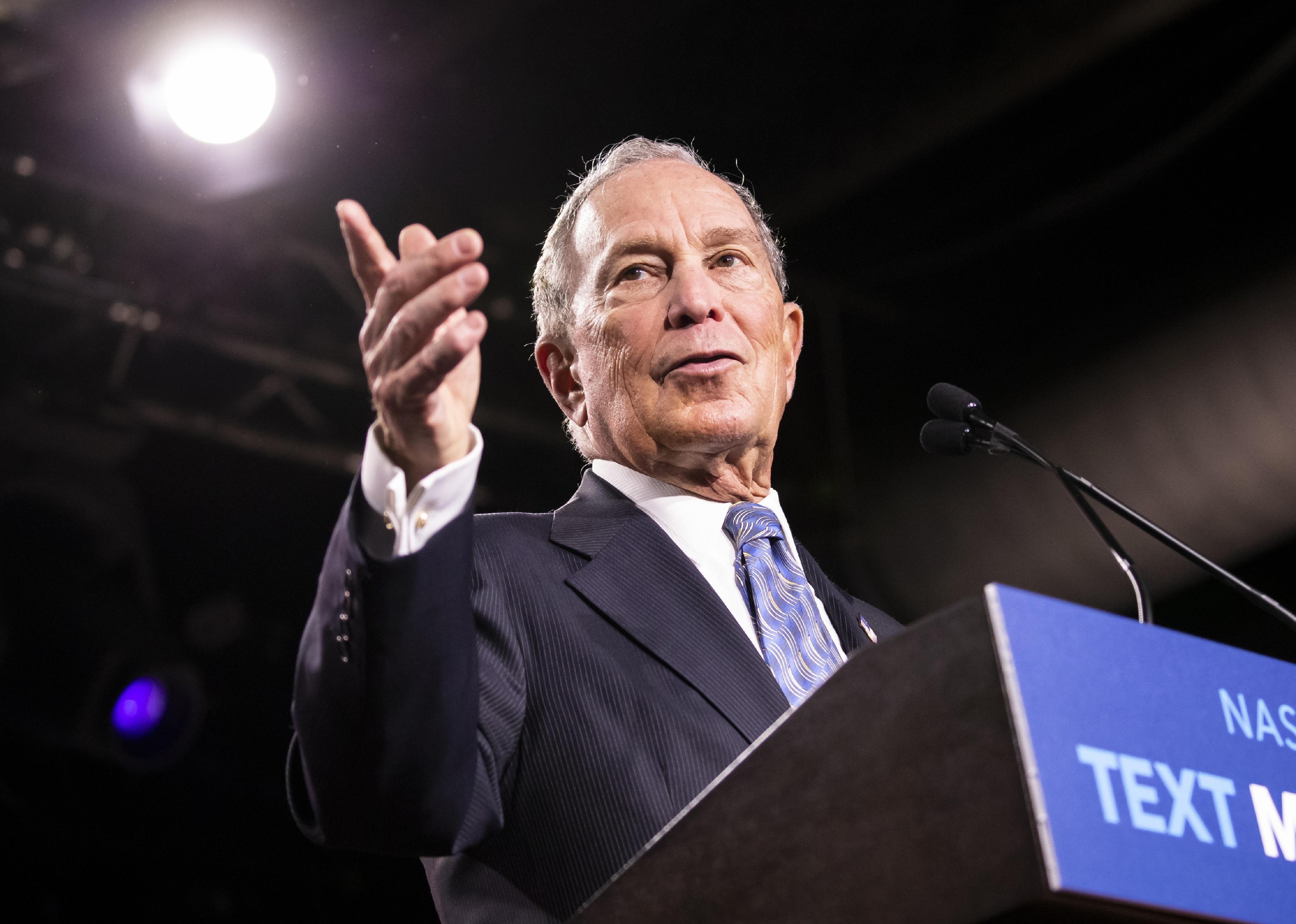Michael Bloomberg speaks at podium.