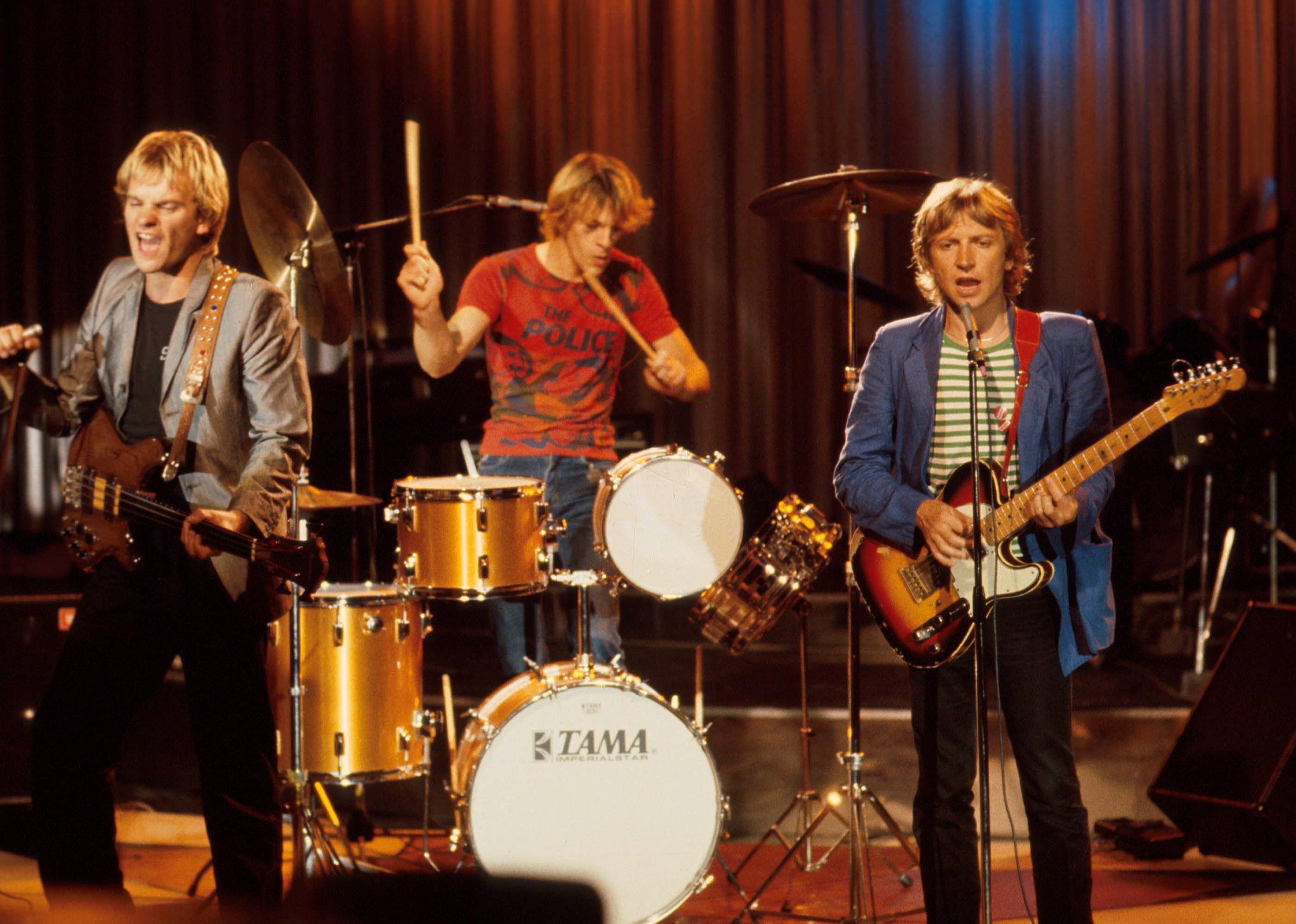 The Police performing onstage.