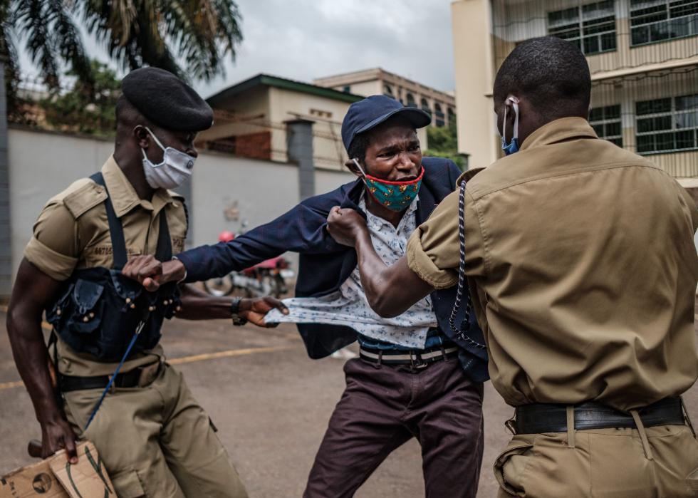 A protester is arrested by police officers